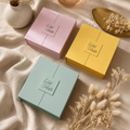 La Trilogie Éclat Céleste - trois coffrets rose, jaune et vert